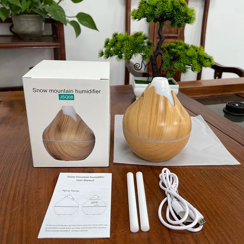 Créez une ambiance zen et apaisante dans votre intérieur avec ce diffuseur d’huiles essentielles 350ml au design grain de bois naturel. Fonction brumisation pour humidifier l'air -7 couleurs LED